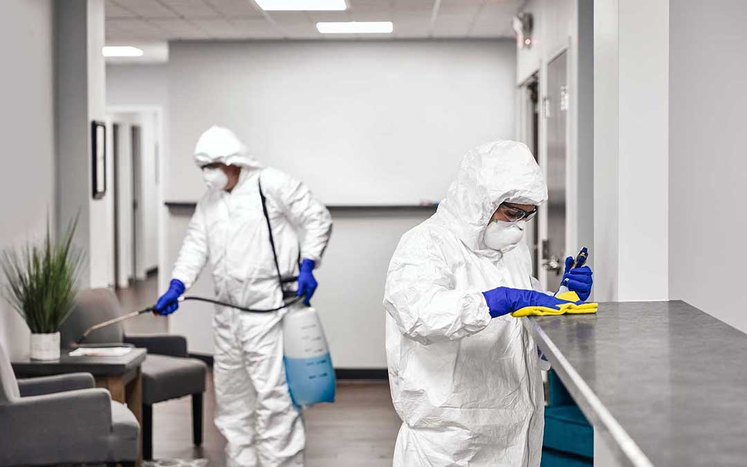 Disinfecting crew deep cleaning an office space